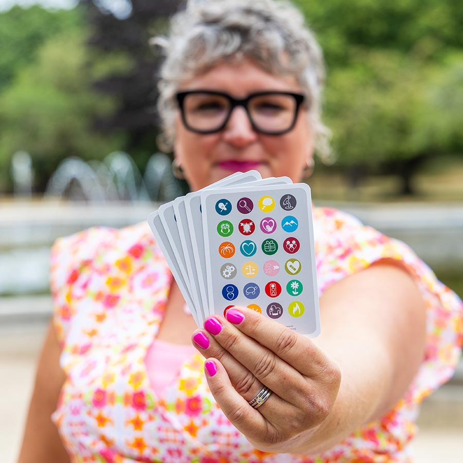 Debbie holding a handful of clarity cards out towards the camera
