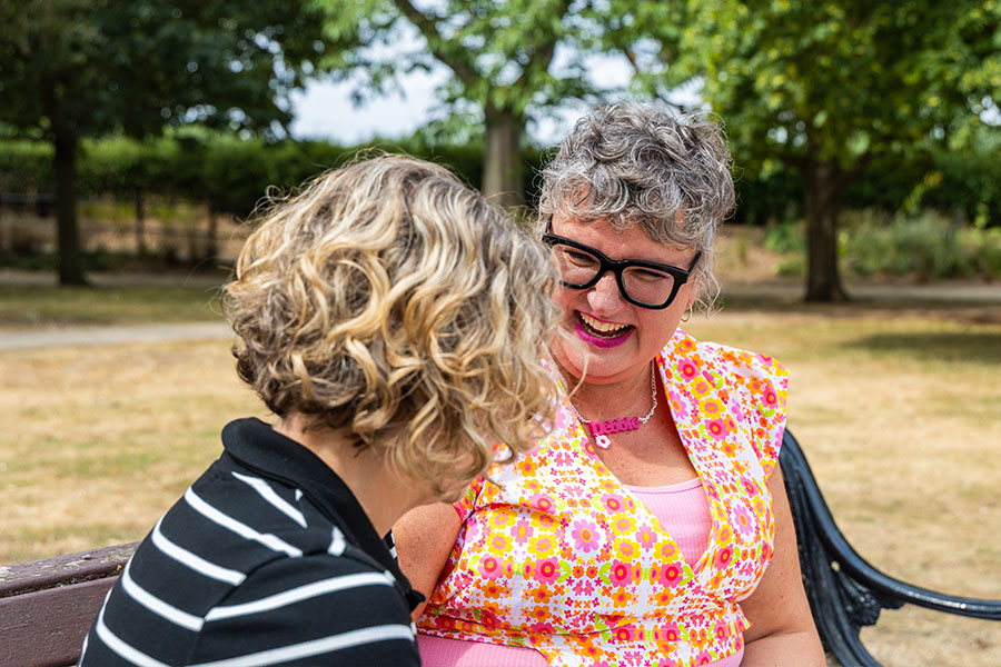 Debbie Draper, The ADHD Coach chatting on a park bench with a client