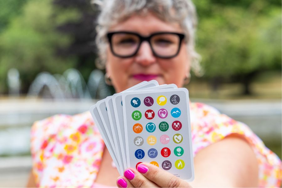 Debbie holding a handful of clarity cards out towards the camera